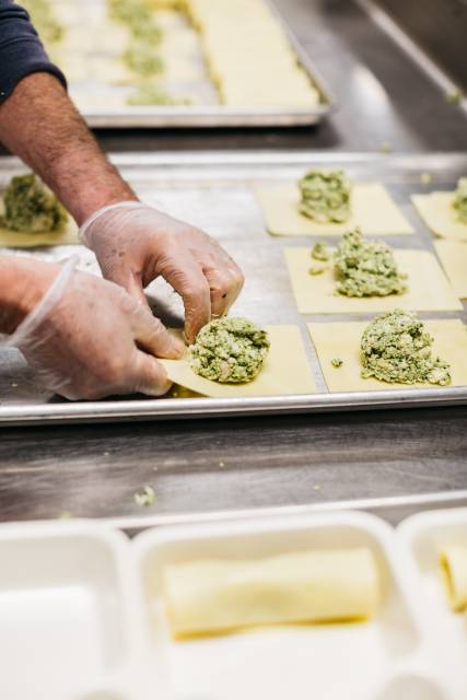 Hands preparing a meal