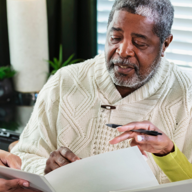 A senior African-American couple meeting with an in-home consultant. 