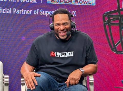 Pro football legend Jerome Bettis, wearing a Live to the Beat tshirt, smiles while being interviewed